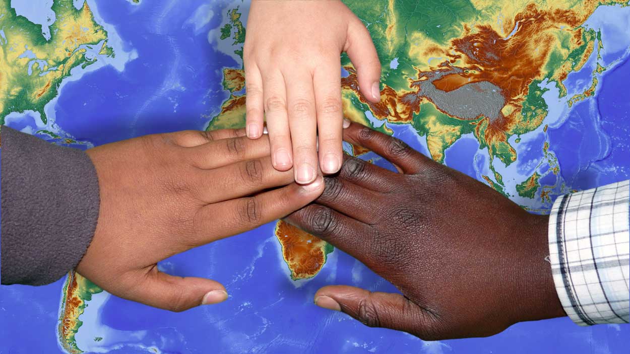 3 Hands placing on map of Africa 