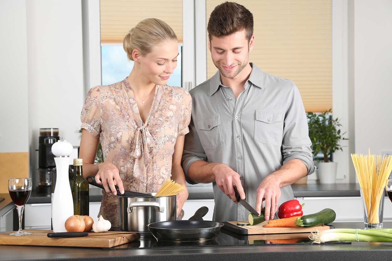 man woman in kitchen