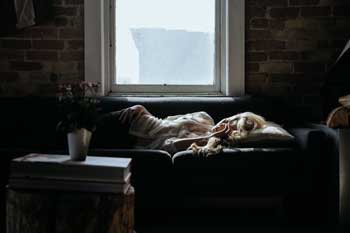 woman lying on couch