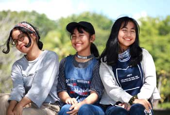 3 girls sitting on fence